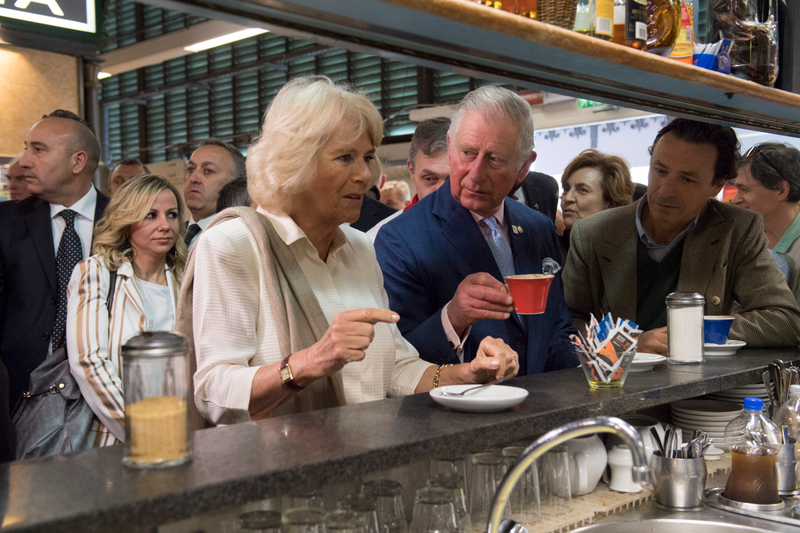 Prince Charles, Prince of Wales drinks his coffee as Camilla, Duchess of Cornwall waits for her drink at the start their day with a coffee at a market shop to celebrate the Slow Food movement during day 4 of their visit to Italy, on April 3, 2017 in Florence, Italy.
